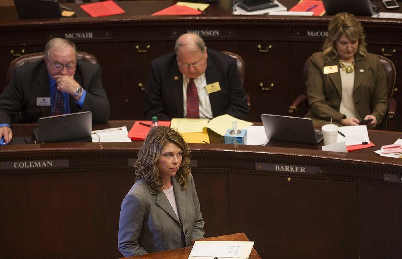 Rep. Michelle Gray, R-Melbourne, listens Monday to opponents of her House Bill 1742 that would limit damages involving a deceptive trade practice. In a 41-38 vote, the bill failed to pass.