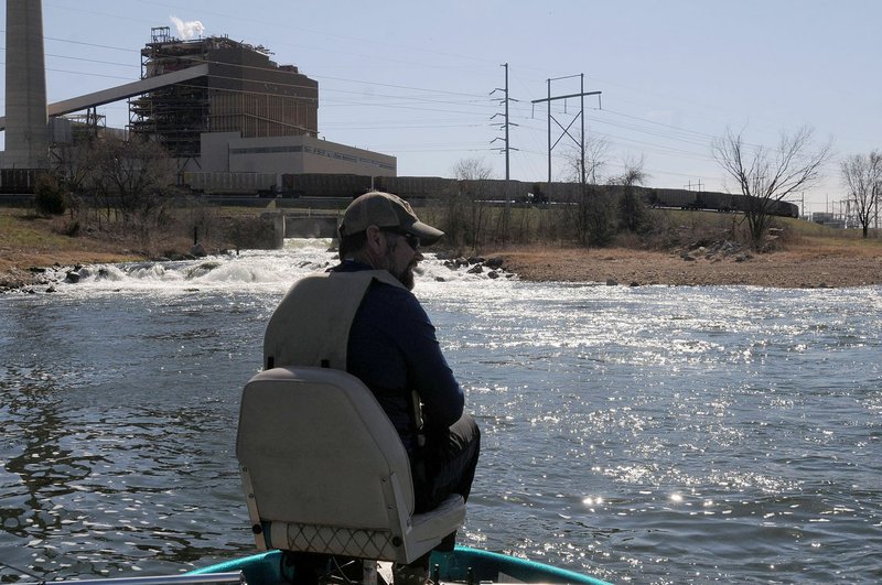 Jon Stein, fisheries biologist with the Arkansas Game and Fish Commission, fishes for black bass Feb. 17 2017 at Swepco Lake near the hot water discharge from the Flint Creek Power Plant west of Gentry. Water is drawn from the lake in the process of making electricity, then discharged back into the lake at a temperature of about 100 degrees. That keeps water temperature warm all winter.