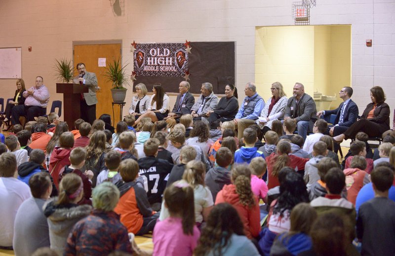 NWA Democrat-Gazette/BEN GOFF &#8226; @NWABENGOFF Students and dignitaries listen Monday as Jason Brunner, interim principal of Old High Middle School, speaks during an assembly at Old High Middle School in Bentonville. &#8220;The reason we&#8217;re all here is for you. We&#8217;re here to celebrate you,&#8221; Brunner told the students.