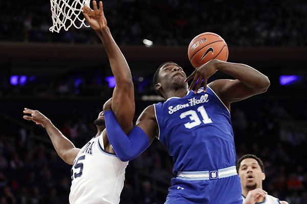 Seton Hall's Angel Delgado (31) and Villanova's Darryl Reynolds (45) fight for control of the ball during the first half of an NCAA college basketball game during the Big East men's tournament Friday, March 10, 2017, in New York. (AP Photo/Frank Franklin II)

