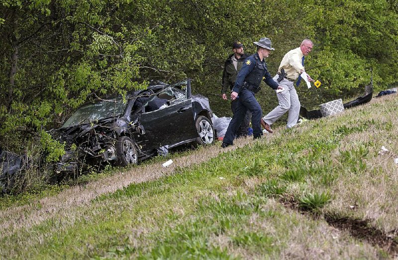 Arkansas Democrat-Gazette/BENJAMIN KRAIN --3/14/17--
Lonoke County Sheriff Department and State Police investigate and accident in North Little Rock that injured two people after they were ejected from a stolen vehicle during a high speed chase. The driver refused to pull over for a Lonoke County sheriff's office deputy during a traffic vilation in Cabot around 12:30 Tuesday and led several other law enforcement vehicles on a pursuit until it hit a tree while exiting Interstate 40 westbound at Highway 167. The driver who had multiple warrants out for his arrest and the passenger were seriously injured after being ejected.
