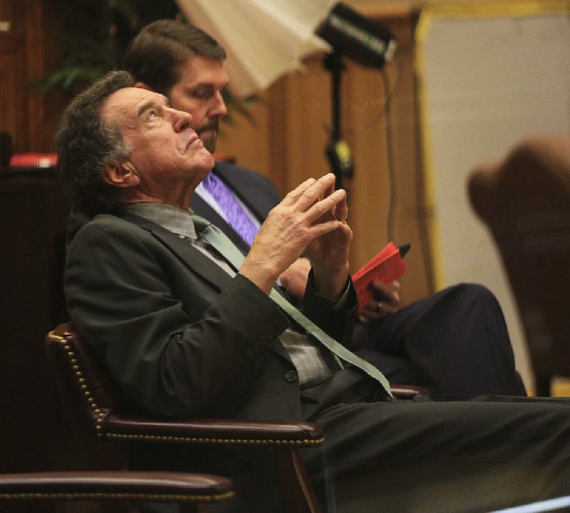 Robert Moore (front), a member of the Arkansas Highway Commission, and Scott Bennett, executive director of the state Highway and Transportation Department, listen to the debate Tuesday on House Bill 1726, the measure for a ballot initiative authorizing the commission to issue bonds for 20 years.