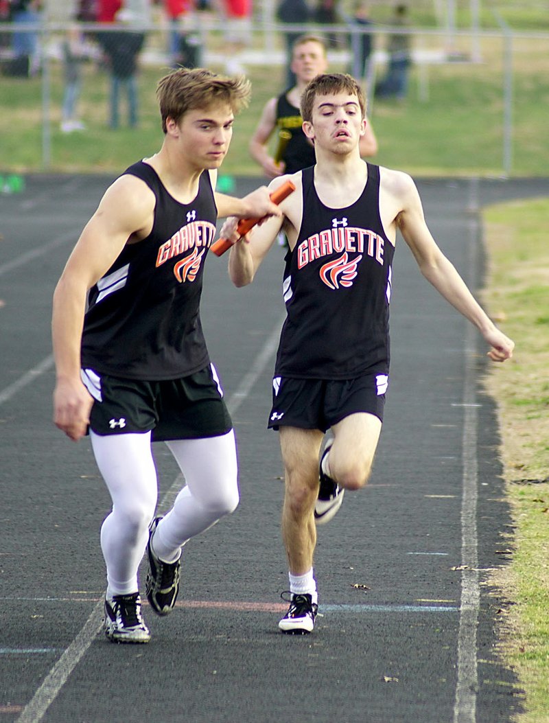Photo by Randy Moll William Crawley passes the baton to Daniel Huntsman during a relay at the Panther Relays track meet held in Siloam Springs on Thursday (March 9, 2017).