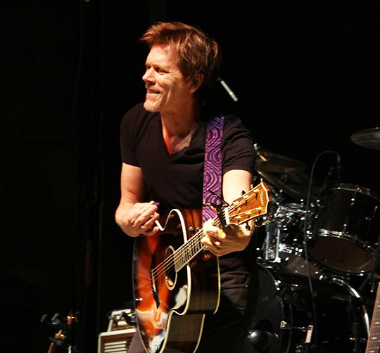 The Sentinel-Record/File photo PARADE DAY: Actor Kevin Bacon performs as part of The Bacon Brothers following the First Ever 13th Annual World's Shortest St. Patrick's Day Parade on March 17, 2016. Parade organizers are concerned that rain may dampen this year's concert.