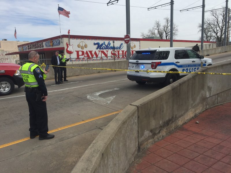 Police block the north side of the Main Street bridge after a wreck killed 2 people Wednesday afternoon.