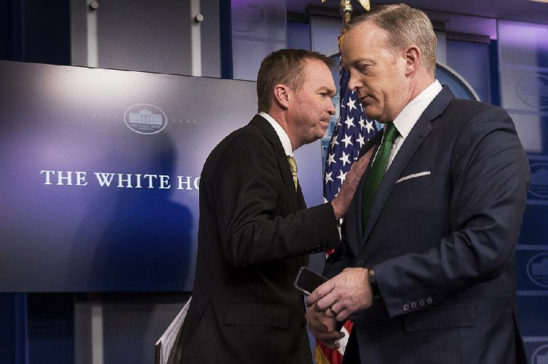 White House spokesman Sean Spicer (right) gives the White House podium Thursday to budget director Mick Mulvaney, who called the budget proposal “a hard-power budget, not a soft-power budget.”