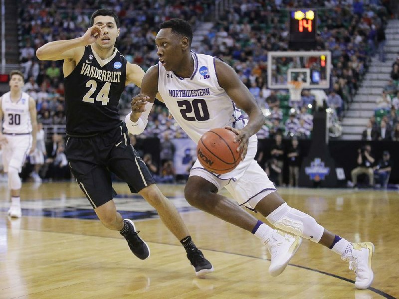 Northwestern guard Scottie Lindsey (20) drives to the basket Thursday past Vanderbilt guard Nolan Cressler (24) during the Wildcats’ 68-66 victory over the Commodores in Salt Lake City.