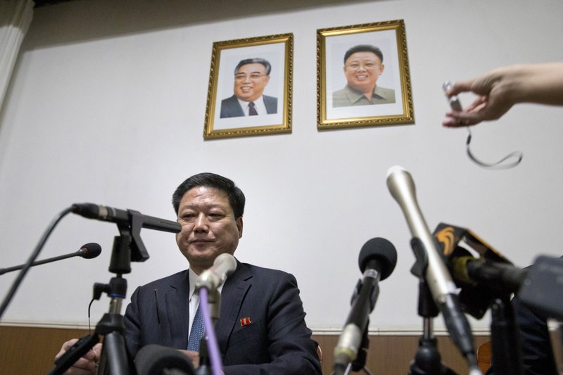 Pak Myong Ho, minister of the North Korean Embassy in China, sits under portraits of the late North Korean leaders Kim Il Sung, left, and Kim Jong Il during a press conference in Beijing, China, Thursday, March 16, 2017. Pak says Pyongyang must act in self-defense against the U.S. and South Korea's joint military drills, which he said have brought the region to the brink of nuclear war. (AP Photo/Ng Han Guan)