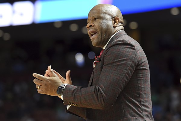 Arkansas head coach Mike Anderson applauds his team against Seton Hall during the first half in a first-round game of the NCAA men's college basketball tournament in Greenville, S.C., Friday, March 17, 2017. (AP Photo/Rainier Ehrhardt)

