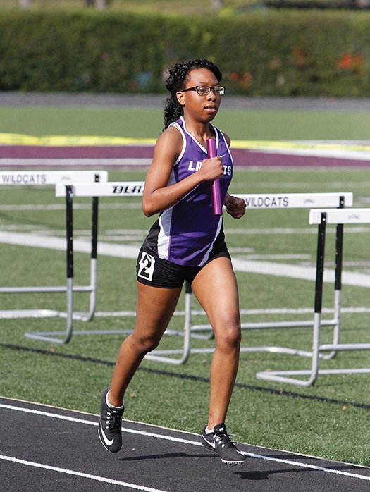 Terrance Armstard/News-Times El Dorado's Kadeshia Lee competes in the 4x800 relay during the Oil Belt Relays at Memorial Stadium on Thursday.