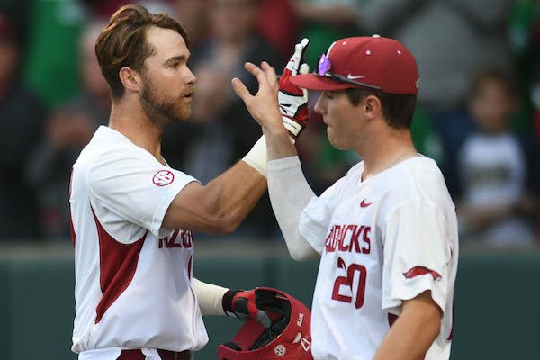 Arkansas left fielder Luke Bonfield (17) is congratulated at the plate by third baseman Carson Shaddy Friday, March 17, 2017, after hitting a 2-run home run scoring Chad Spanberger during the first inning against Mississippi State at Baum Stadium in Fayetteville. 