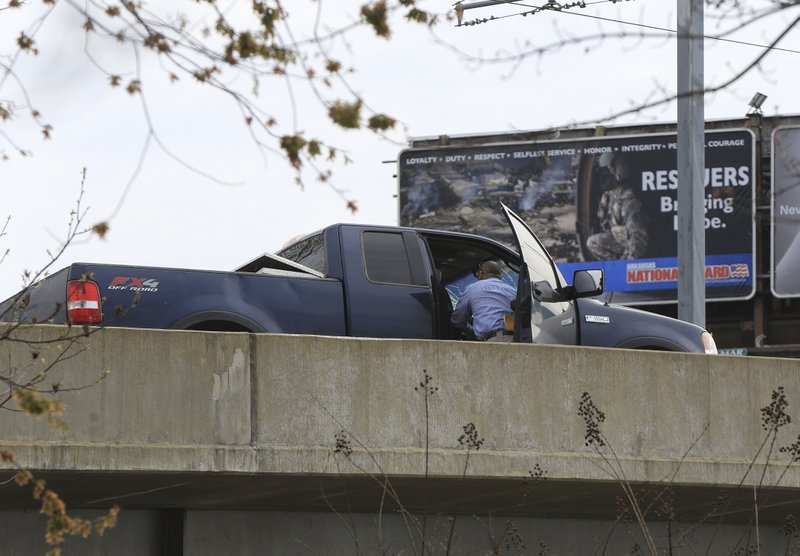 North Little Rock Police check a pickup that was traveling the wrong direction on the Main Street Bridge when it hit a bicyclist Wednesday afternoon on the Main Street Bridge. The bicyclist and the pickup driver were both killed.
