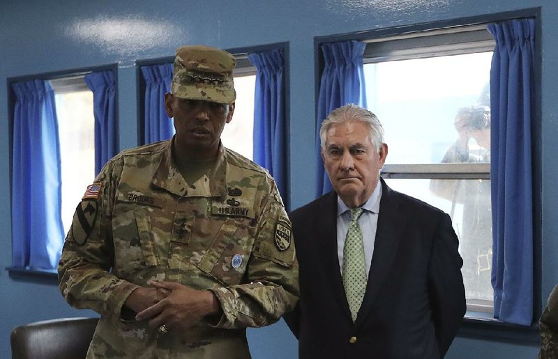 Secretary of State Rex Tillerson visits with Gen. Vincent Brooks, commander of the combined forces in South Korea, on Friday in Panmunjom. 