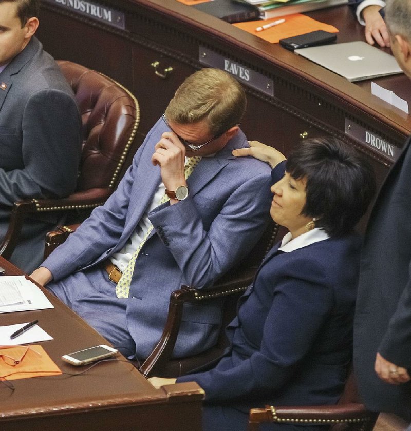 An emotional Rep. Grant Hodges, R-Rogers, House sponsor of Senate Bill 519, receives a comforting pat from Rep. Mary Bentley, R-Perryville, on Friday after the House approved the bill to separate the Robert E. Lee and Martin Luther King Jr. holidays.