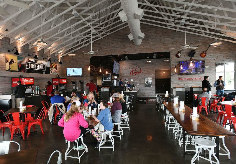Patrons dine at Slim Chickens in Fayetteville. The Arkansas-based restaurant chain recently opened its 51st location.