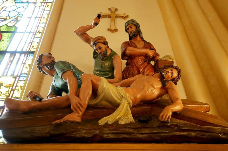 Station 11 at St. Edward Catholic Church in Little Rock depicts Jesus being nailed to the cross. The 14 stations follow Jesus’ path to the crucifixion. 