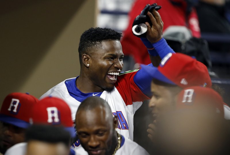 Dominican Republic's Jose Reyes, left, celebrates with teammate