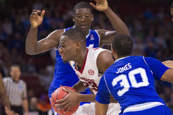 Arkansas' Moses Kingsley drives to the basket between Seton Hall's Angel Delgado and Madison Jones (30) Friday Mar. 17, 2017 during the first round of the NCAA Tournament at the Bon Secours Wellness Arena in Greenville, South Carolina. Arkansas won 77-71 and will advance to the second round, playing Sunday at the same location.