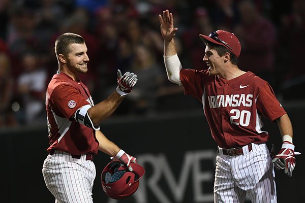 Arkansas' Chad Spanberger is greeted at home plate after hitting a home run against Mississippi State. 