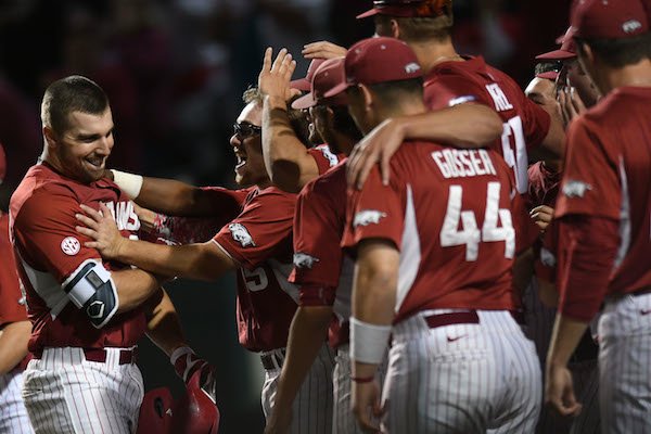 Arkansas first baseman Chad Spanberger (left) celebrates with Jake Arledge and other teammates after Spanberger's 3-run home run against Mississippi State Saturday, March 18, 2017, during the second inning at Baum Stadium in Fayetteville. Visit nwadg.com/photos to see more photographs from the game.