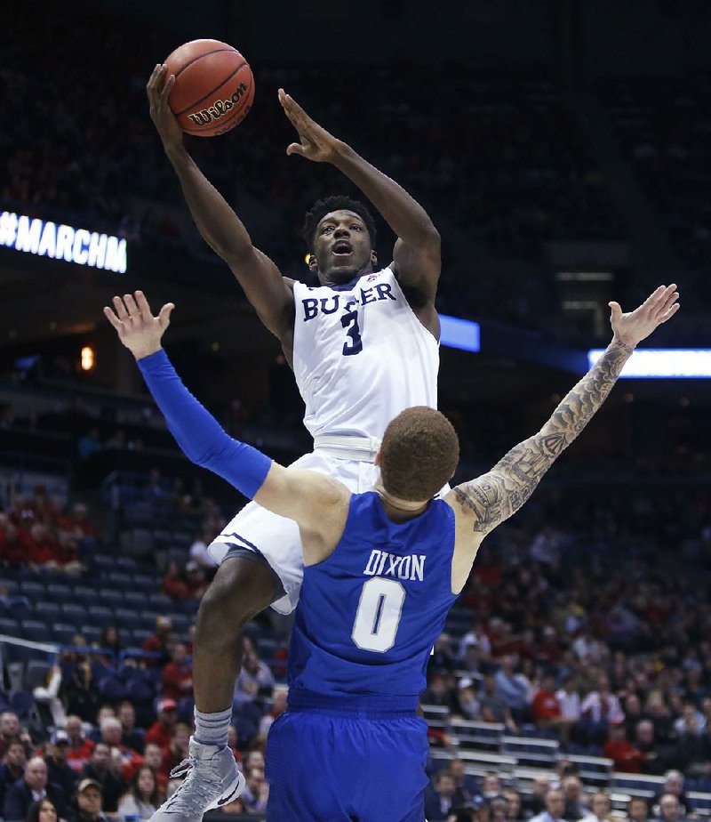Butler guard Kamar Baldwin (3) shoots over Middle Tennessee State guard Tyrik Dixon on Saturday during the Bulldogs’ 74-65 victory over the Blue Raiders in Milwaukee.