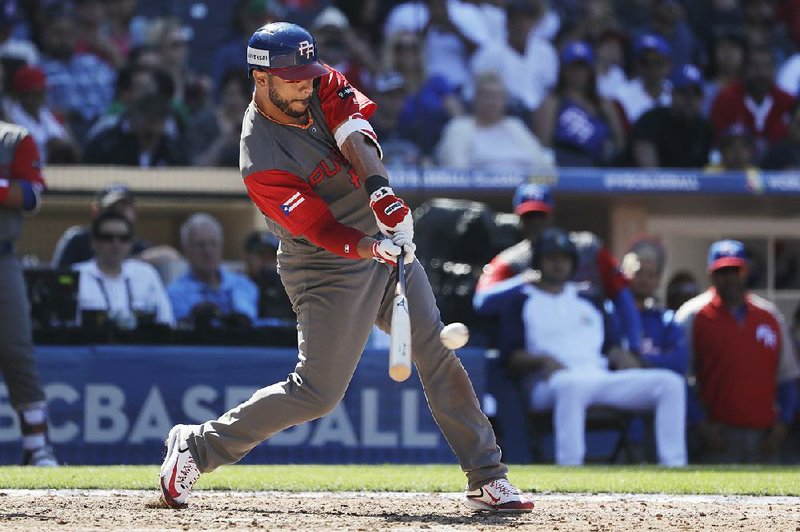 Puerto Rico outfielder Mike Aviles hits a two-run single, one of his four hits, in the seventh inning of a 13-2 victory over Venezuela in San Diego on Saturday in the second round of the World Baseball Classic.