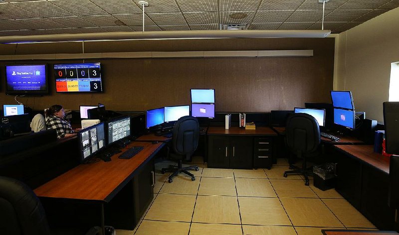 Call-takers work next to empty seats Thursday at the Little Rock 911 Communications Center, where understaffing has long been a problem.