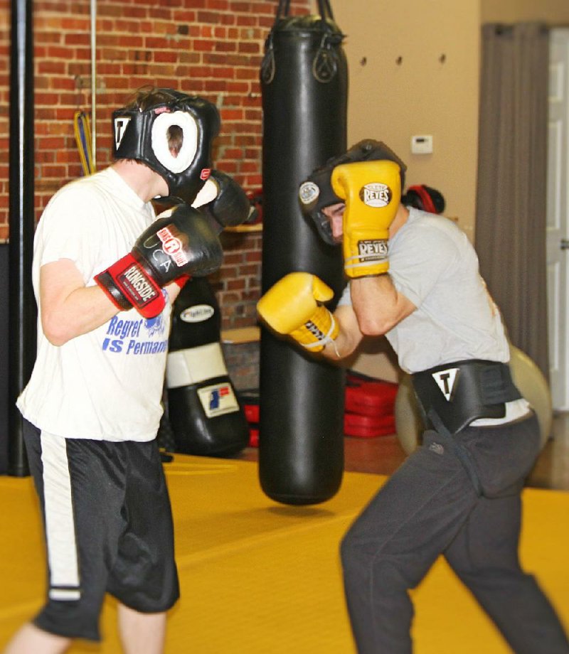 A teenage participant (left) spars with a University of Central Arkansas student volunteer during a boxing program for boys ages 13-18 who are on juvenile-court probation.
