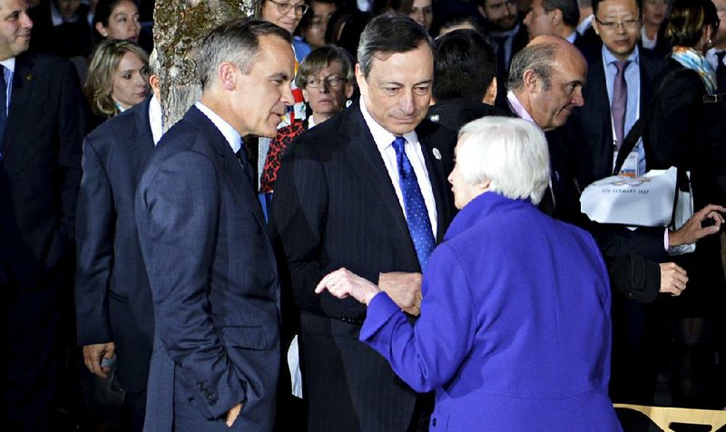 Federal Reserve Chairman Janet Yellen speaks with Mark Carney (left), governor of the Bank of England, and Mario Draghi, president of the European Central Bank, during the G-20 finance ministers meeting Saturday in Baden-Baden, Germany. 