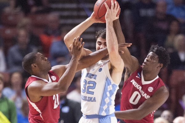 Arkansas' Manuale Watkins (left) and Jaylen Barford cover North Carolina's Luke Maye Sunday March 19, 2017 during the second round of the NCAA Tournament at the Bon Secours Wellness Arena in Greenville, South Carolina. The Tar Heels beat the Razorbacks 72-65 eliminating them from the tournament.