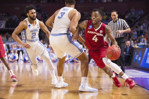 Arkansas' Daryl Macon drives around North Carolina's Kennedy Meeks Sunday March 19, 2017 during the second round of the NCAA Tournament at the Bon Secours Wellness Arena in Greenville, South Carolina.