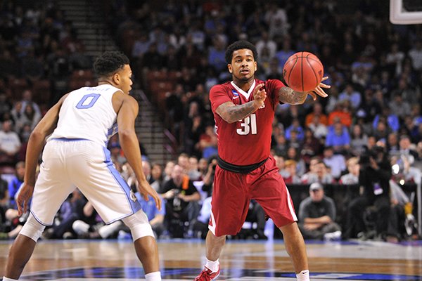Arkansas guard Anton Beard passes the ball during a game against North Carolina on Sunday, March 19, 2017, in Greenville, S.C.
