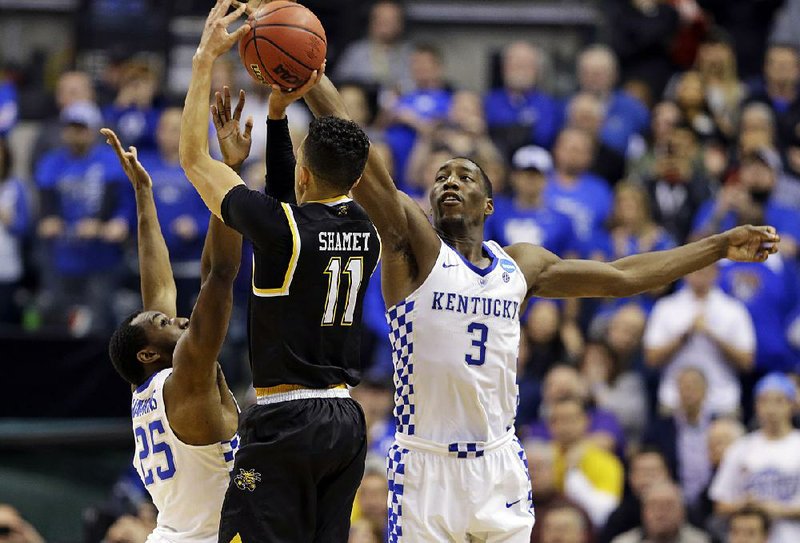 Kentucky forward Bam Adebayo (right) swats away a potential game-tying shot from Wichita State’s Landy Shamet to advance to the Sweet 16 with a 65-62 victory in Indianapolis.