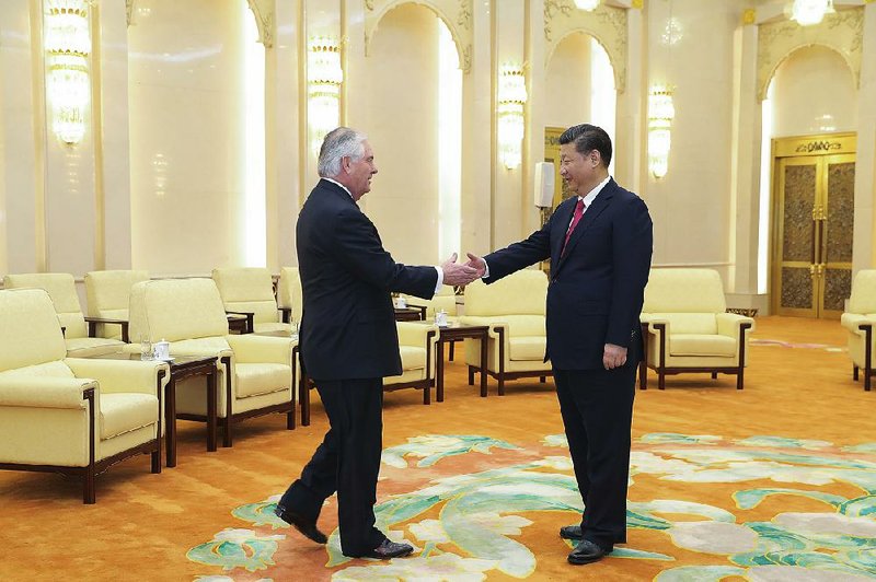 U.S. Secretary of State Rex Tillerson (left) greets China’s President Xi Jinping at the Great Hall of the People on Sunday in Beijing.