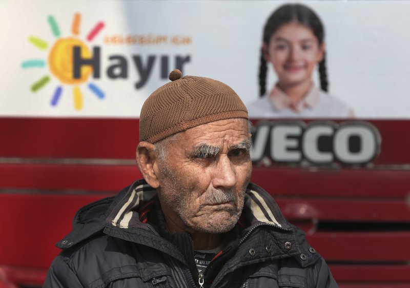 In this Wednesday, March 15, 2017 photo, a Turkish supporter of the 'NO' vote for the upcoming referendum sits at a campaign tent in central Istanbul. 