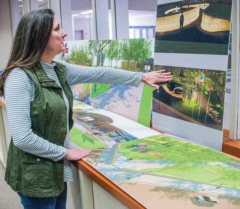 Julie Allen, executive director of the Newport Area Chamber of Commerce, points out the veterans memorial in this conceptual drawing of the downtown park that is under construction in Newport. The park, which is being designed by Mesa Landscape Architects of Little Rock, will also include an amphitheater. Chamber officials recently honored businesses and individuals at the annual banquet, also noting events of the past and of the future, including building this park.