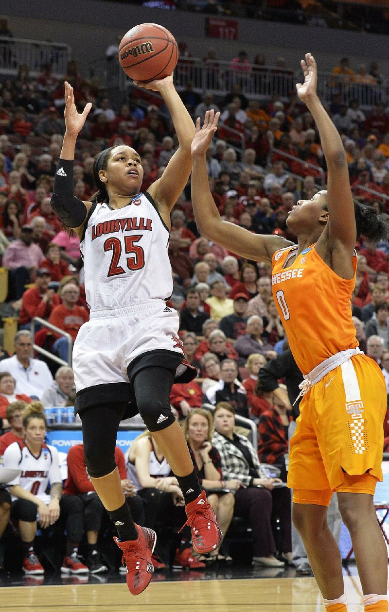 Louisville guard Asia Durr (left) shoots over Tennessee defender Jordan Reynolds during the second half of their game in the Oklahoma City Regional of the NCAA Women’s Tournament on Monday. Durr’s 23 points carried the Cardinals to a 75-64 victory.