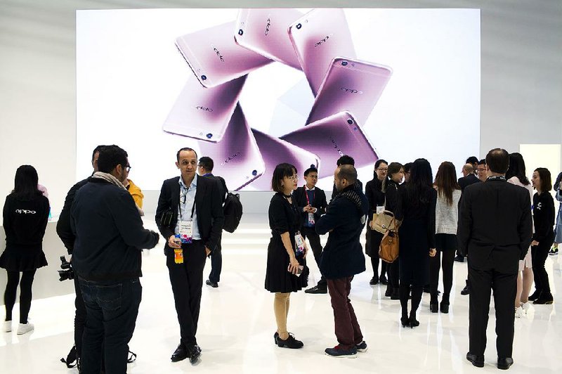 People visit the Oppo smartphones area last month at the Mobile World Congress wireless show in Barcelona, Spain. Oppo phones outsold Apple Inc. phones in China last year.
