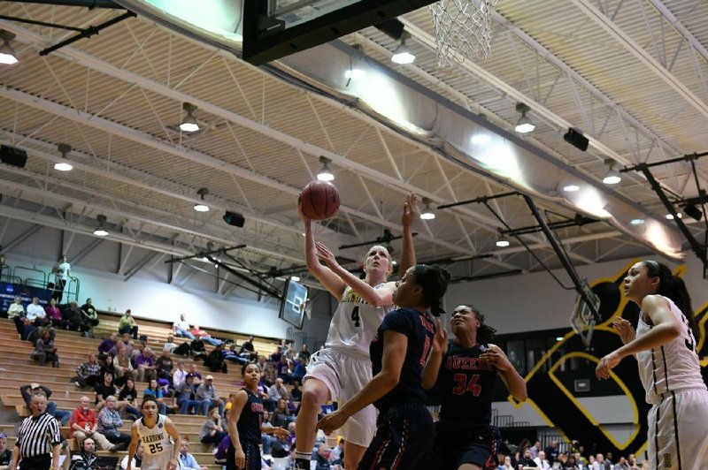 Harding forward Mackenzie McNamara (left) puts up a shot in the Lady Bisons’ 73-69 victory over Queens (N.Y.) College on Tuesday in the NCAA Division II women’s tournament in Columbus, Ohio.