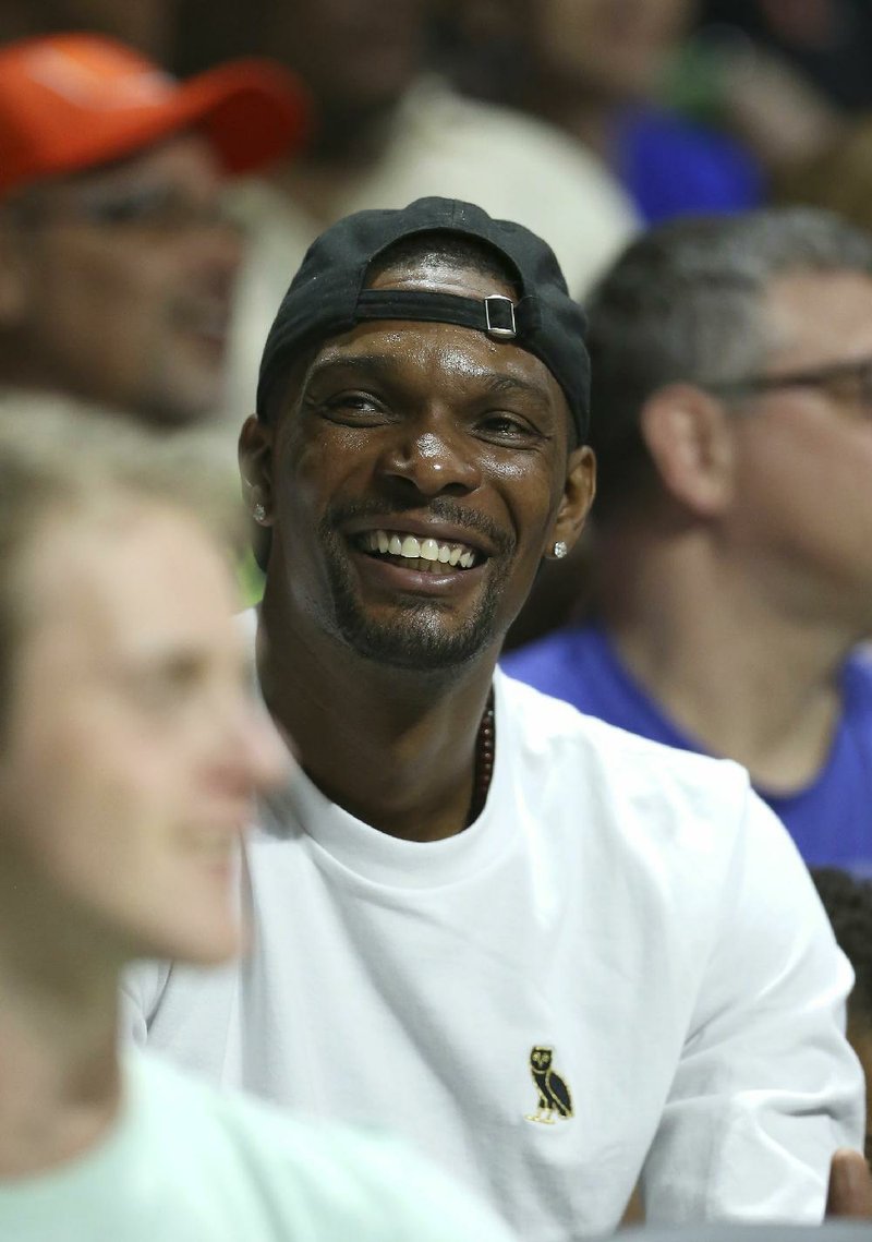 Miami Heat forward Chris Bosh smiles during the first half of an NCAA college basketball game between Miami and Duke in Coral Gables, Fla., on Saturday, Feb. 25, 2017. 