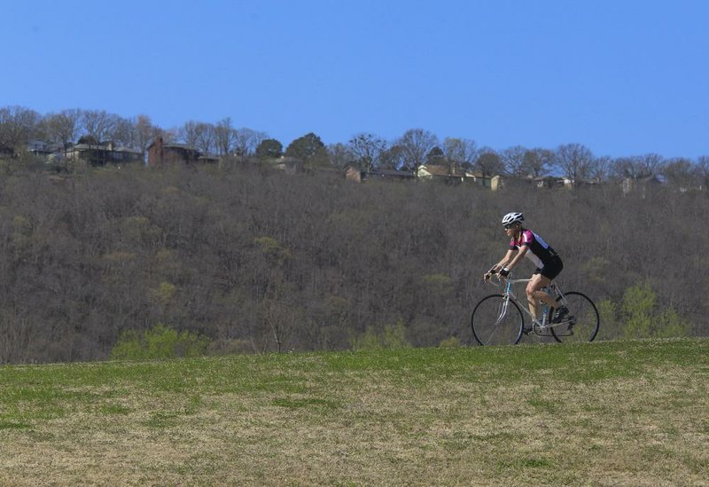 A cyclist at Two Rivers Park in Little Rock takes advantage of Tuesday’s unseasonably warm weather to get in a ride. Temperatures reached the upper 80s in the area.
