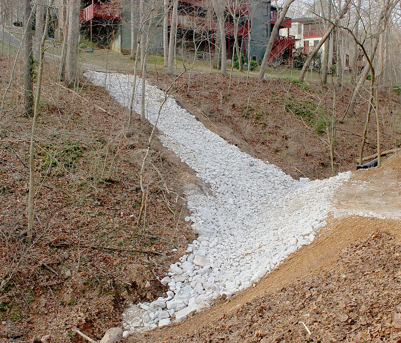 Keith Bryant/The Weekly Vista Drainage improvements the Townhouse Association made in the valley behind Clubhouse Drive, as seen from Annette Lane. The large rocks, called riprap, are reinforced with a concrete slurry. The intent is to reduce erosion in the valley.