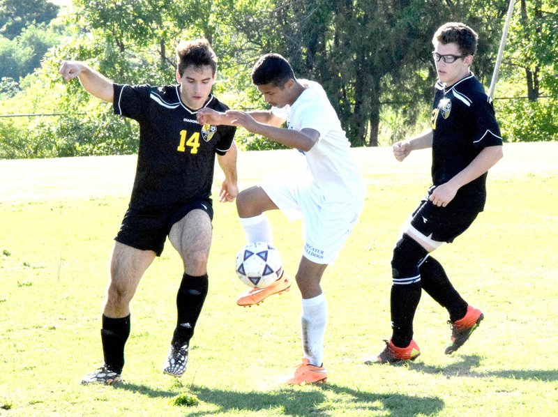 Photo by Mike Eckels Decatur&#8217;s Jimmy Mendoza (center) gains control of the ball from a Tiger player during the May 3 Decatur-Prairie Grove soccer match at Bulldog Stadium in Decatur. Mendoza returns to the Decatur soccer program for the 2017 season opener March 28 at Subiaco Academy.