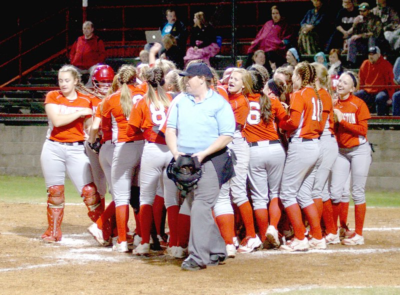 MARK HUMPHREY ENTERPRISE-LEADER The Farmington girls softball team celebrates a home-run by senior Brandy Wallace during an 8-0 Lady Cardinal win over Lincoln in the Farmington/Fayetteville Invitational Softball tournament held last weekend.