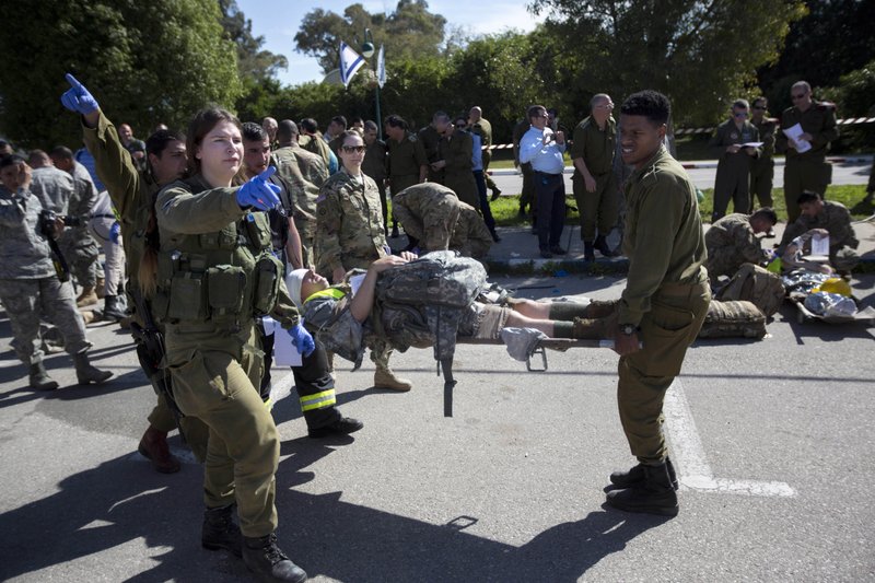 In this Tuesday, March 1, 2016 file photo, American servicemen and Israeli soldiers participate in a joint drill simulating a rocket attack at a base in Hatzor, central Israel.