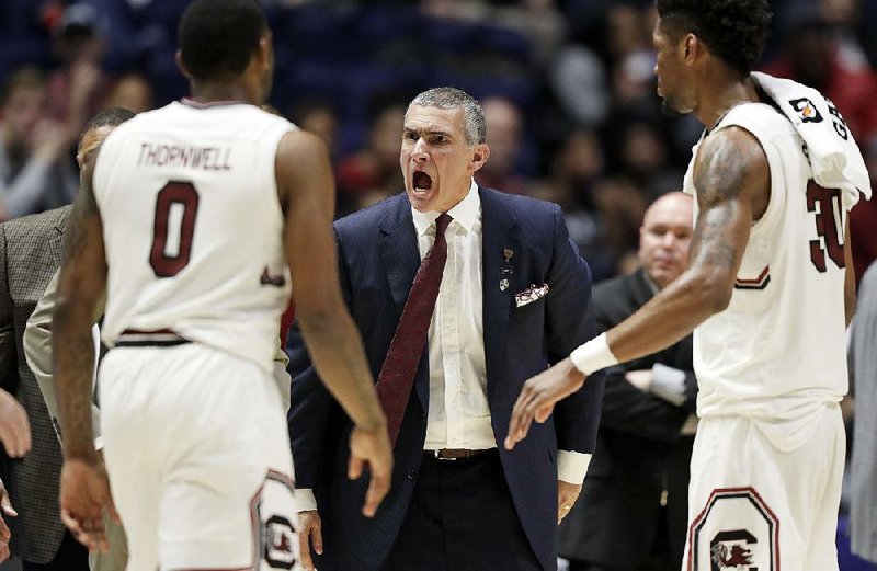 South Carolina Coach Frank Martin (center) has the Gamecocks in the Sweet 16 of the NCAA Tournament for the first time since 1973. In fact, the SEC has three teams in the regional semifinals, which is tied with the Pac-12, Big Ten and Big 12 for the most this year.   