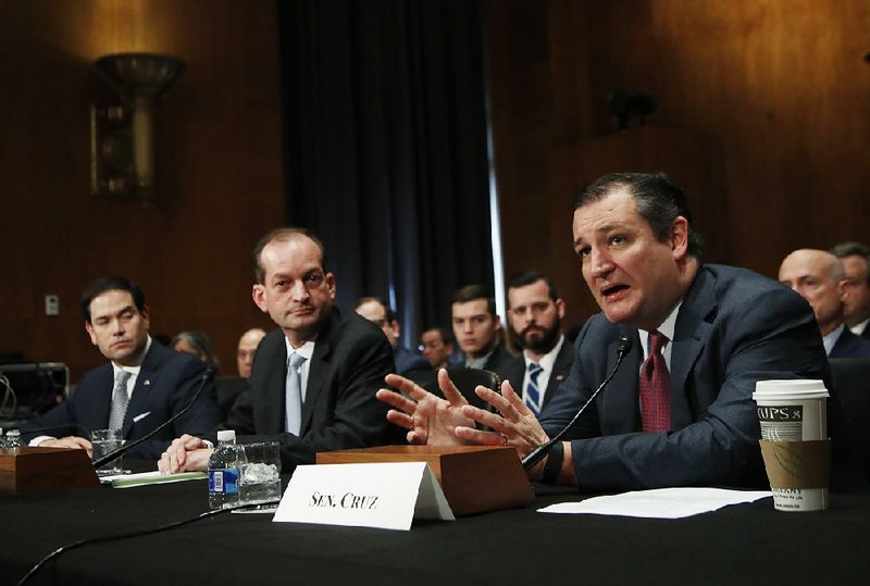 Labor Secretary nominee Alexander Acosta is flanked during his confirmation hearing Wednesday on Capitol Hill by Sens. Marco Rubio (left) and Ted Cruz. 