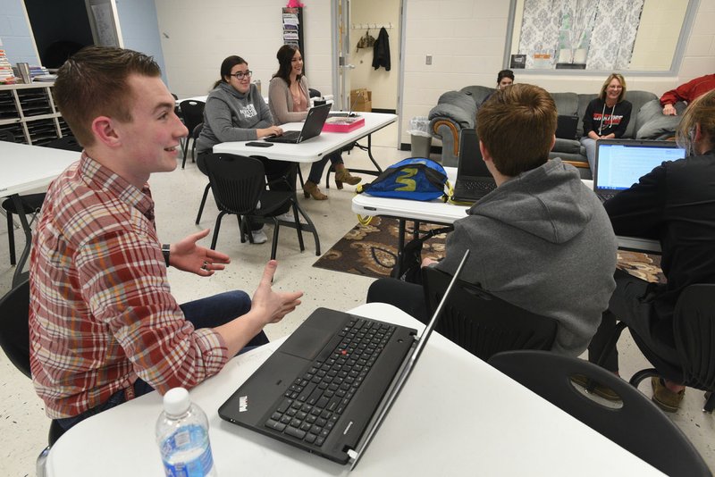 NWA Democrat-Gazette/FLIP PUTTHOFF Logan Johnson (left) takes part in a global marketing class March 16 at Pea Ridge Manufacturing and Business Academy at Pea Ridge High School.