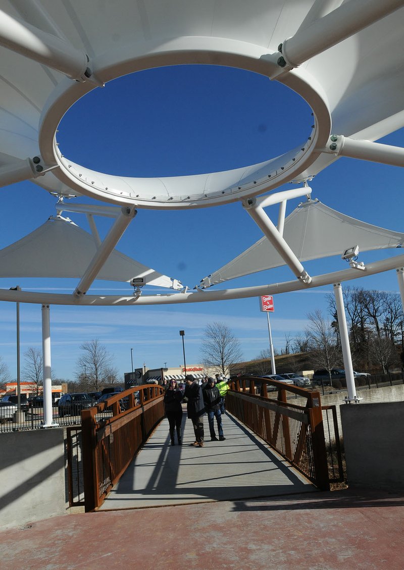 NWA Democrat-Gazette/FLIP PUTTHOFF Guests at the dedication Jan. 4 of the New Hope Bridge along the Northwest Arkansas Regional Greenway in Rogers stroll across the span after a ribbon cutting ceremony. The bridge is open for foot and bicycle traffic near Interstate 49 and New Hope Road. The bridge replaces an old route through the area that ran beside New Hope Road. It increases safety by taking Greenway users away from busy New Hope Road, said Rogers Mayor Greg Hines at the dedication.