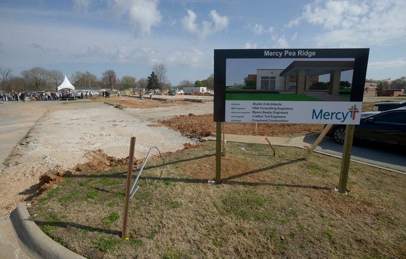 NWA Democrat-Gazette/BEN GOFF @NWABENGOFF A sign displays a rendering March 9 during a groundbreaking ceremony for Mercy Clinic Primary Care in Pea Ridge. The facility is the first of seven clinics Mercy plans to build in the region, along with a new tower at Mercy Hospital in Rogers, as part of a $247 million expansion plan. The Pea Ridge clinic is scheduled to be done in August and will be staffed with two primary care providers, a physician and nurse practitioner.